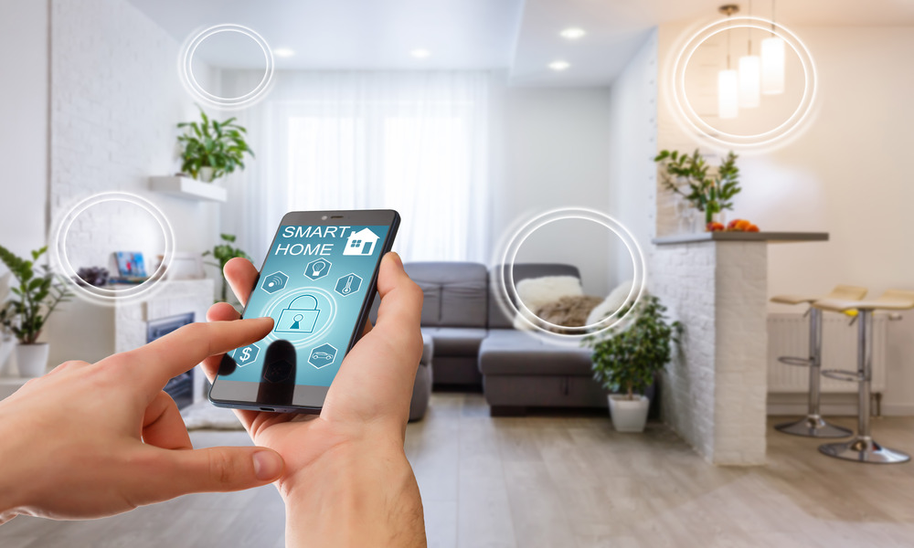 A hand holding a smartphone about to press a lock button in their home's living room. The phone reads "smart home".